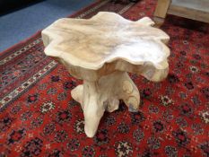 A rustic hardwood tree trunk stool.