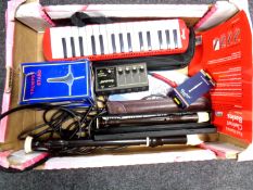 A box containing musical items including Stagg Melodion with case, recorders, trumpet stand,
