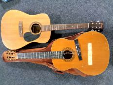 An Encore electro-acoustic guitar together with a Leonora classical guitar in carry bag.