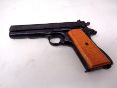 A Umarex 8mm starting pistol in the form of a Colt 1911, with magazine.