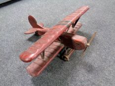 A wooden model of a biplane.