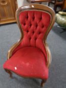 A Victorian style lady's chair upholstered in red button dralon.