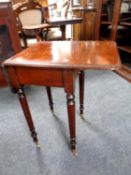 A Victorian mahogany flap sided occasional table with a fitted draw on brass castors.