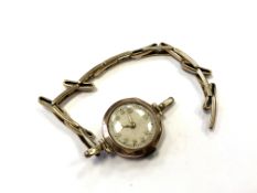 A lady's wrist watch with 9ct gold back on plated expansion strap
