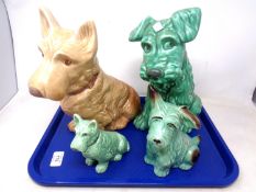 A tray of four Sylvac pottery dog ornaments.