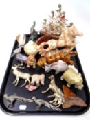 A tray containing polished stone, ceramic and metal animal figures.