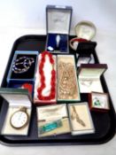 A tray containing an Ingersoll Triumph pocket watch, costume jewellery,