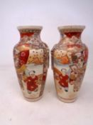 A pair of Japanese earthenware Satsuma vases (height 20.5cm).