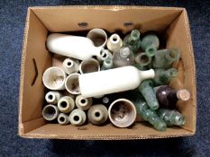 A box of antique glass and stoneware bottles.