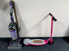 A Vax upright vacuum cleaner together with a Razer scooter.
