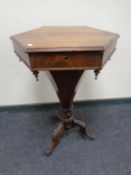 A Victorian rosewood hexagonal sewing table on three way pedestal.