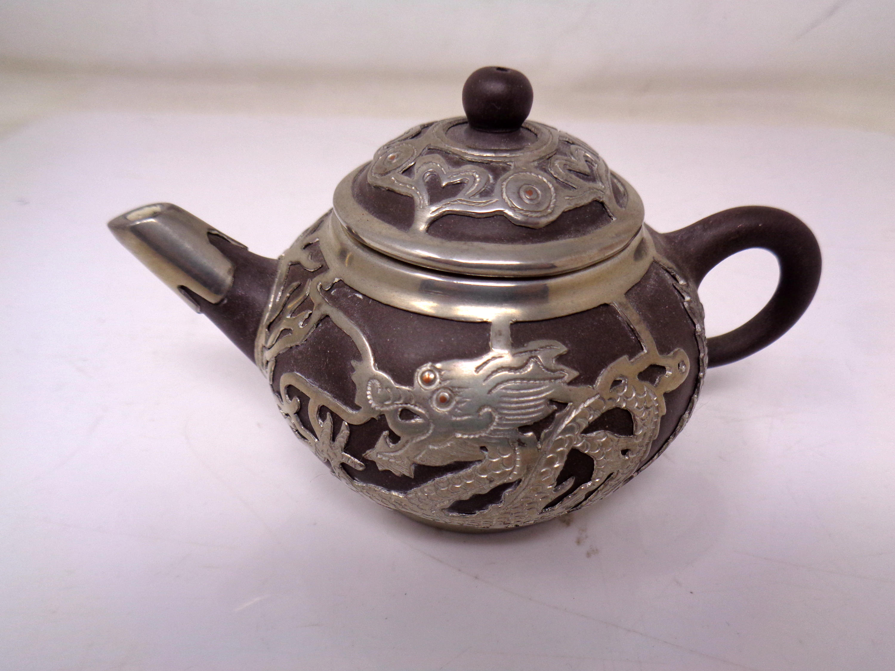 A Chinese stoneware and white metal mounted teapot (height 7cm).