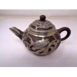 A Chinese stoneware and white metal mounted teapot (height 7cm).