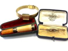 A 9ct gold bar brooch together with silver mounted cheroot holder and gold plated wrist watch (3)