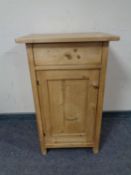 An antique pine pot cupboard fitted with a drawer.