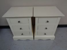 A pair of John Lewis three drawer bedside chests in cream finish.