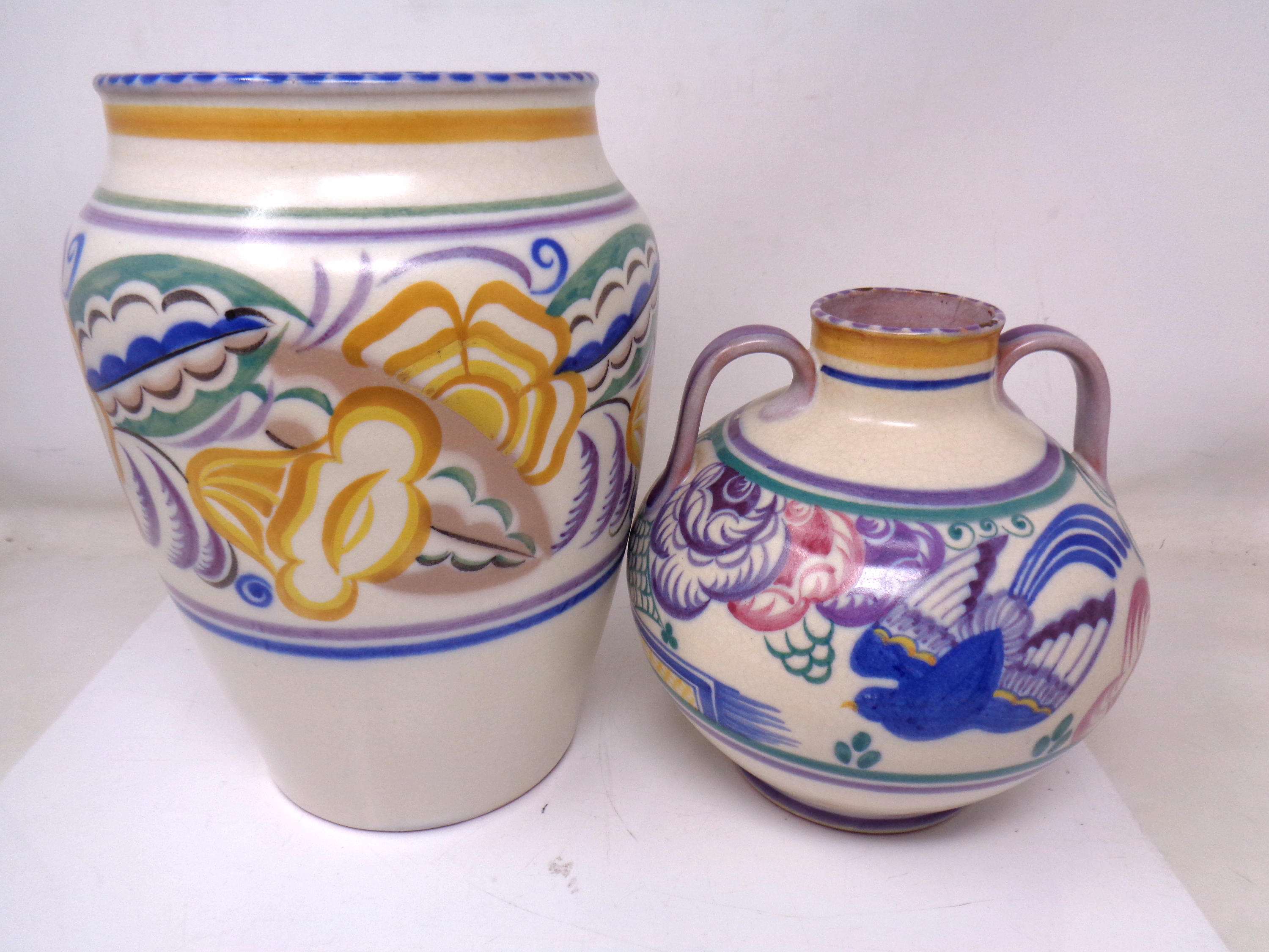 A Poole pottery vase together with a similar twin handle vase (tallest 23.5cm).