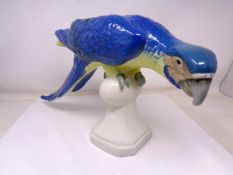 A Royal Dux china figure of a parrot perched on finial (height 22cm).
