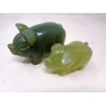 Two carved jade pig figures (largest 8cm long).