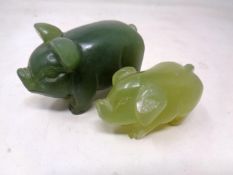 Two carved jade pig figures (largest 8cm long).