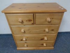 A pine two-over-three five drawer chest.