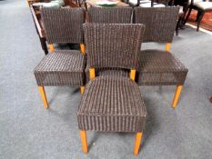 A set of four contemporary rattan dining chairs.