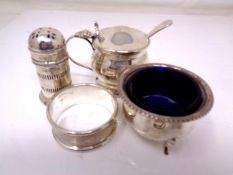 A group of silver items including a sifter, a napkin ring,