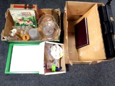 A box containing two artist's folios, watercolour paper and further art supplies.