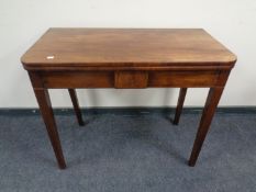 A Victorian inlaid mahogany D-shaped turnover top tea table.