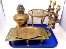 A tray containing antique and later brass ware including trivets, Art Deco tray,