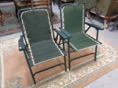 A pair of folding garden armchairs.