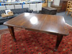 A 19th century oak wind out dining table with fitted leaves.