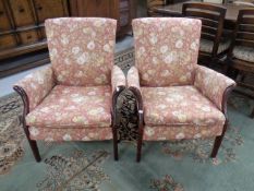 A pair of Parker Knoll fireside armchairs upholstered in floral fabric.