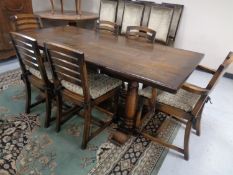 A good quality oak refectory dining table together with a set of six rush seated ladder back chairs,
