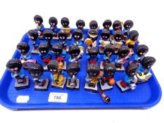 A tray containing a quantity of ceramic Robertson's Golly band figures.