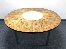 Richard Young for Merrow Associates: A circular rosewood dining table on chrome legs with inset