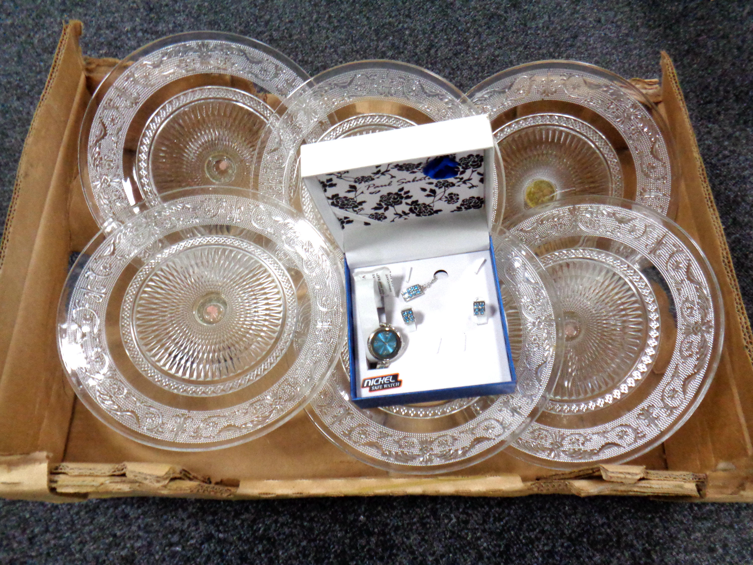 A box of pressed glass dishes together with a lady's costume wristwatch, pendant and earring set.