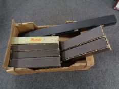 A box containing nine pianola rolls together with a snooker cue case.