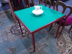 A folding baize topped card table together with a Tyne potteries floral pattern jug and basin.