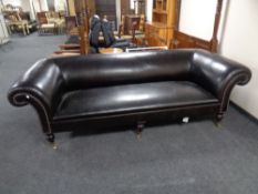 A George Smith brown leather Chesterfield settee on brass castors.
