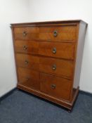 A late Victorian inlaid mahogany three drawer chest with cupboard fitted beneath.