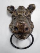 A cast iron boar head horse hitch.