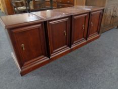 Four contemporary mahogany bedside cupboards.