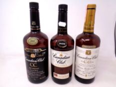 Three bottles of Canadian Club Whisky (1 Litre and 1.44 Litres).
