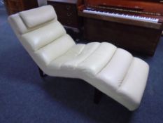 A contemporary cream leather chaise longue.