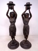 A pair of bronze Egyptian Revival figural candlesticks (height 39cm).
