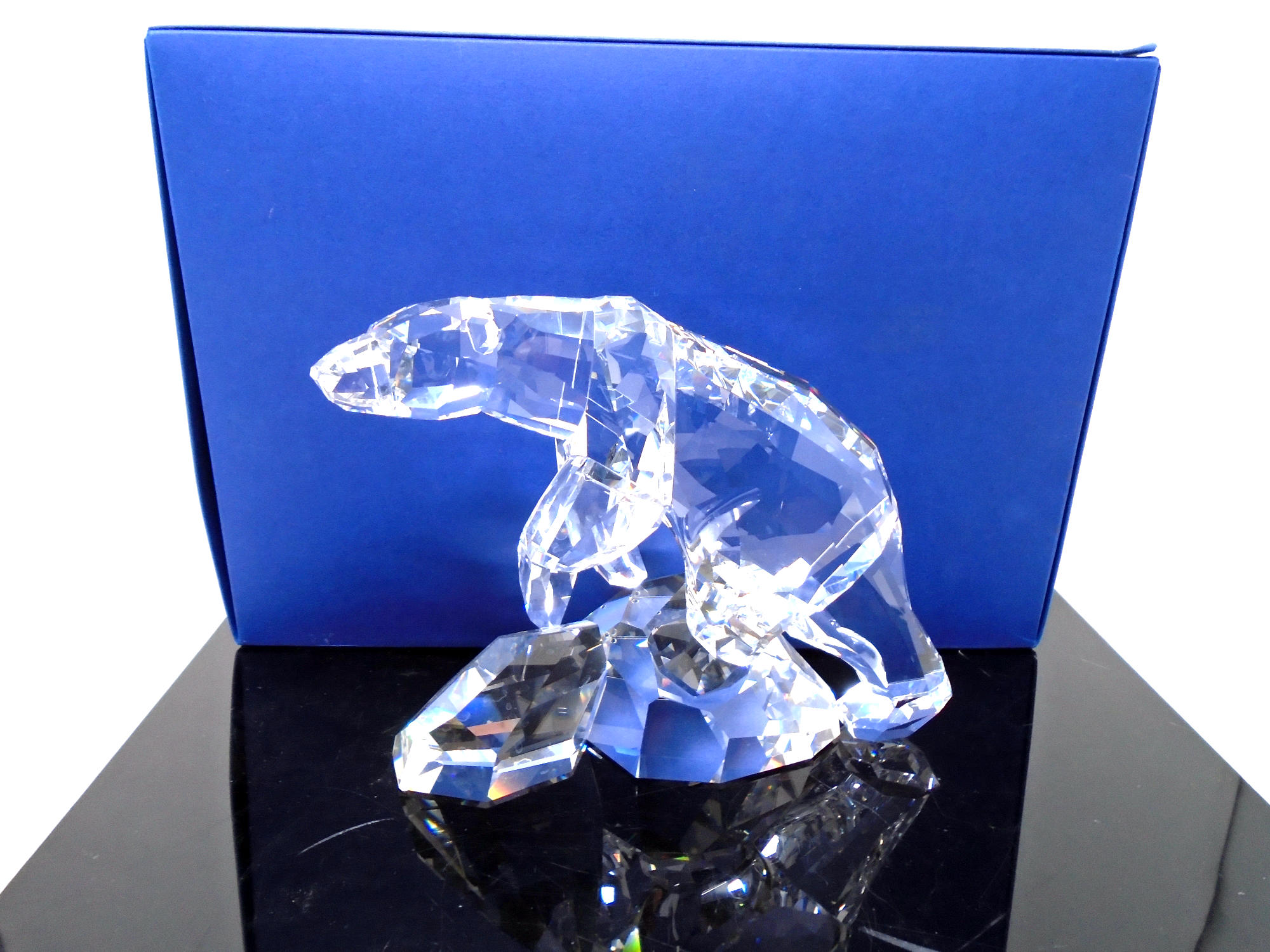 A Swarovski crystal ornament, polar bear on rock.