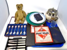 A tray containing Wedgwood Coronation plate, mohair teddy bear, cased cutlery, vintage games,