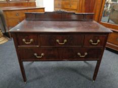 A 19th century mahogany four drawer chest with brass drop handles on raised legs.