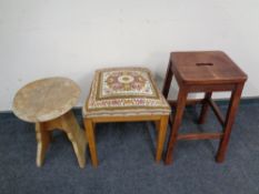 A tapestry upholstered stool together with two further stools.